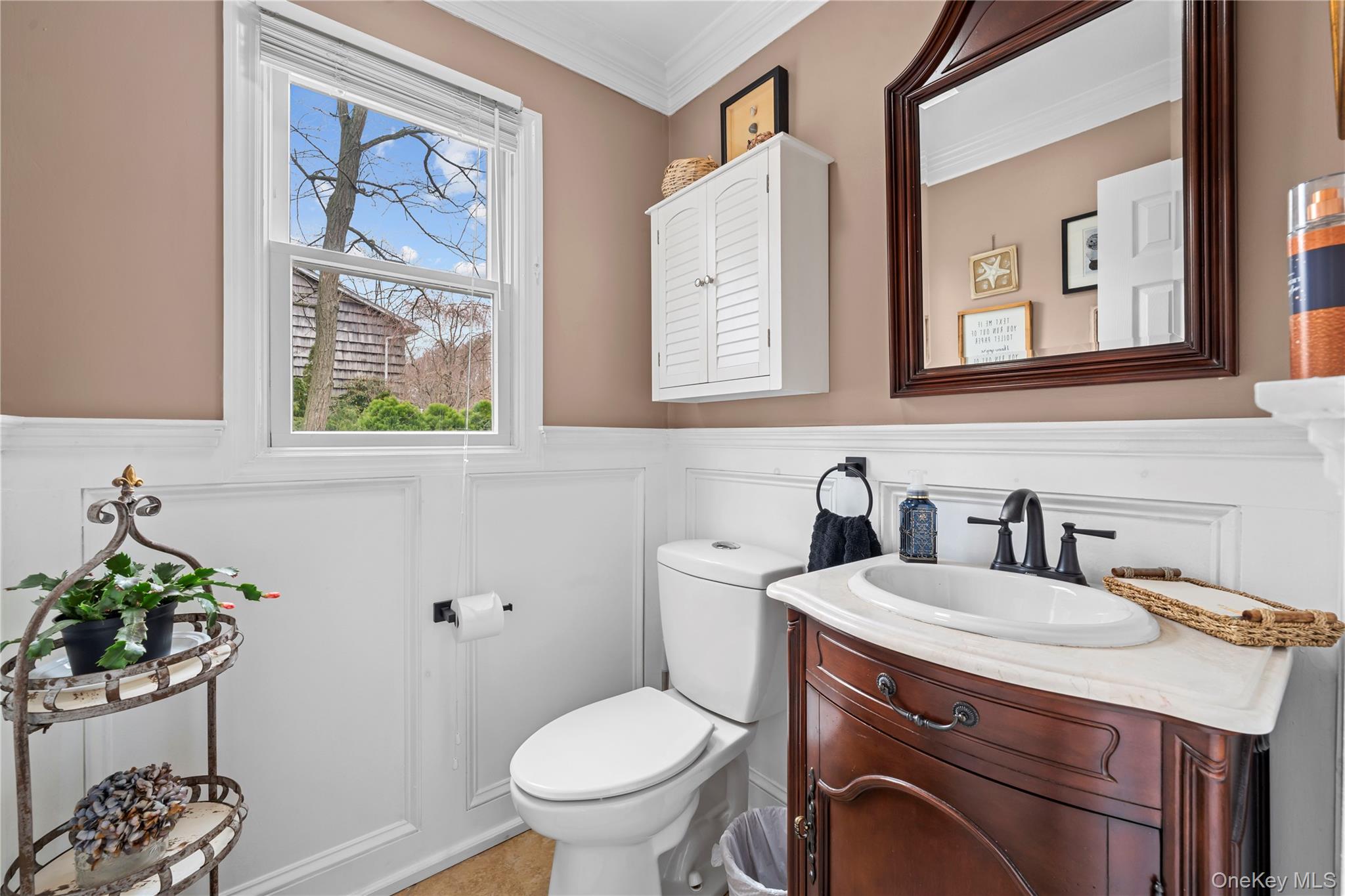 29 Dyke Road Setauket, NY 11733 - Photo 28 of 44 a bathroom with a toilet a sink and mirror