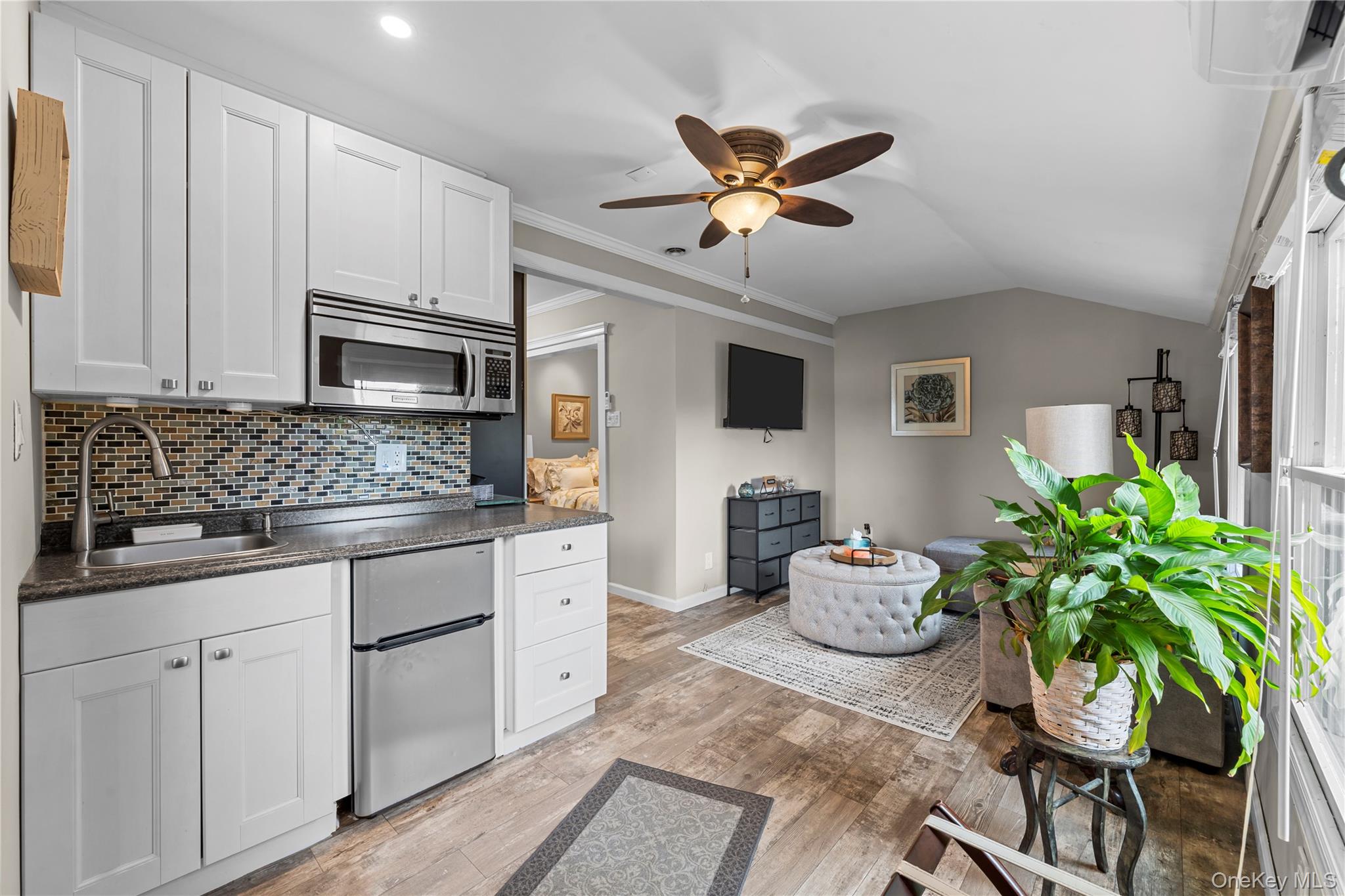 29 Dyke Road Setauket, NY 11733 - Photo 30 of 44 a kitchen with stainless steel appliances kitchen island granite countertop a sink and cabinets