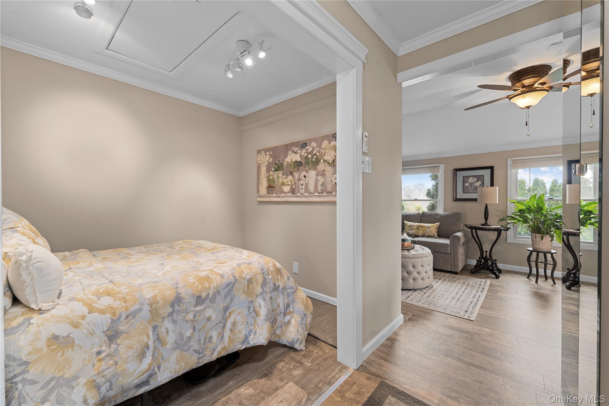 29 Dyke Road Setauket, NY 11733 - Photo 31 of 44 a bedroom with a large bed a chandelier and a window