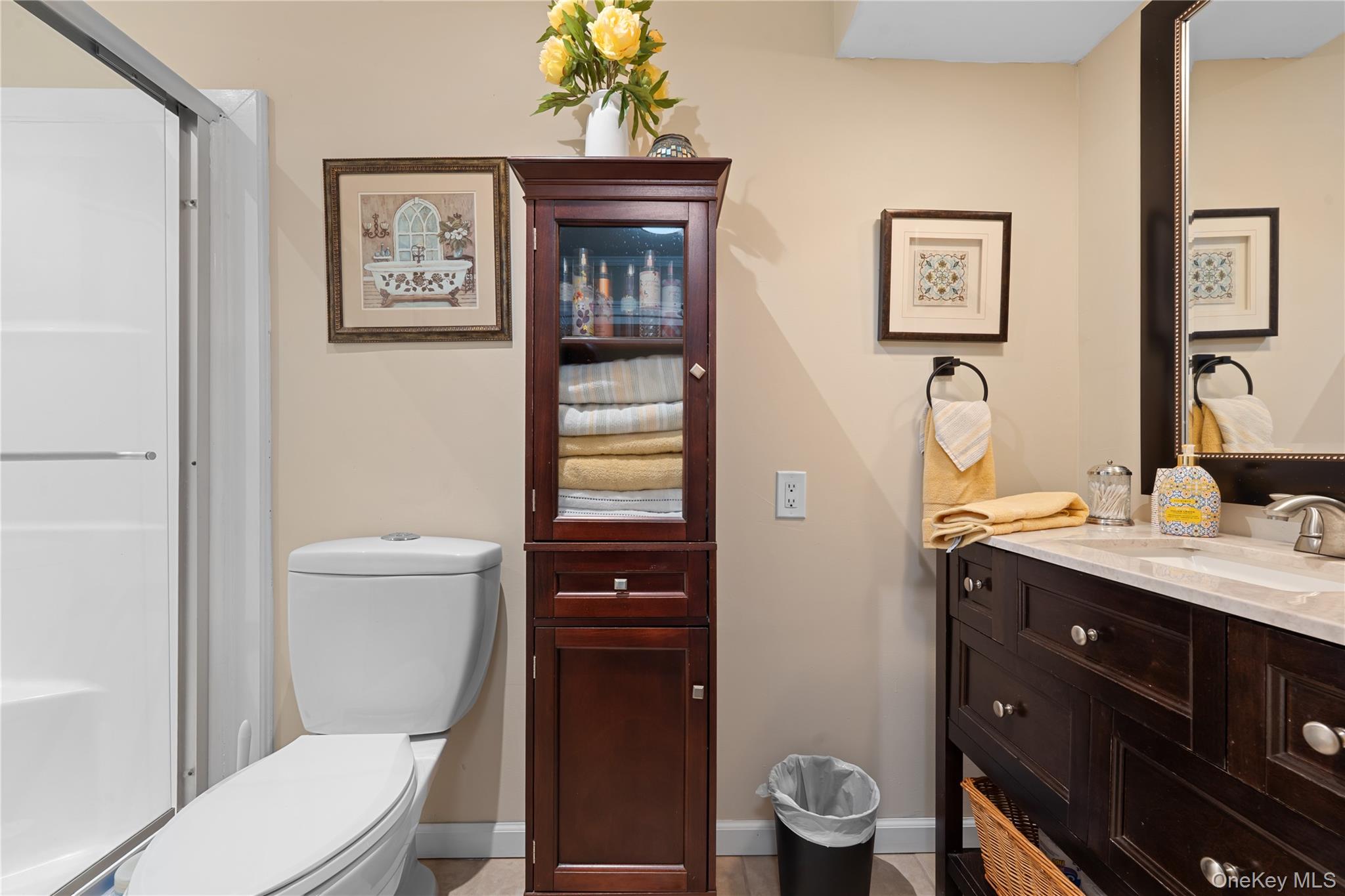 29 Dyke Road Setauket, NY 11733 - Photo 32 of 44 a bathroom with a toilet a sink and mirror