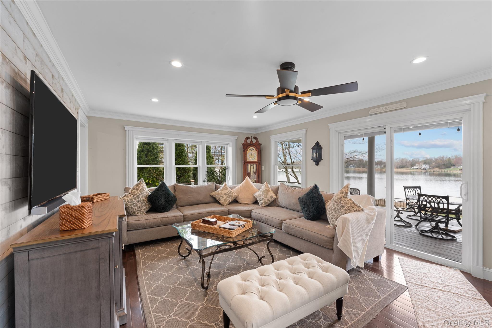 29 Dyke Road Setauket, NY 11733 - Photo 10 of 44 a living room with furniture ceiling fan and a flat screen tv