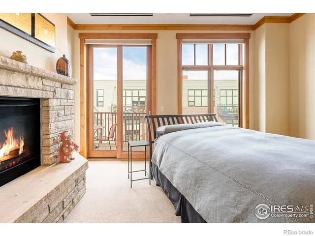 a spacious bedroom with a bed and a fireplace