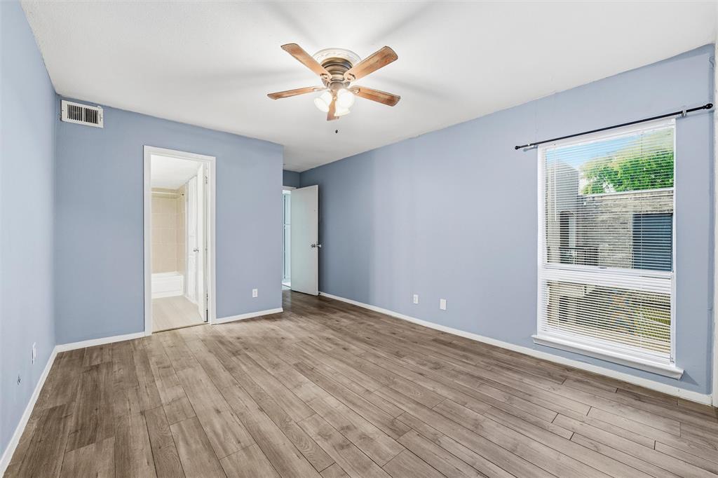 5604 Boca Raton Boulevard, Unit 248 Fort Worth, TX 76112 - Photo 14 of 25 a view of an empty room with wooden floor and a window