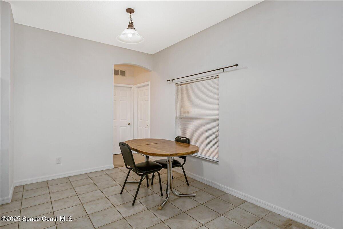 1062 Morgan Circle Northeast Palm Bay, FL 32905 - Photo 13 of 52 a room with furniture and a window