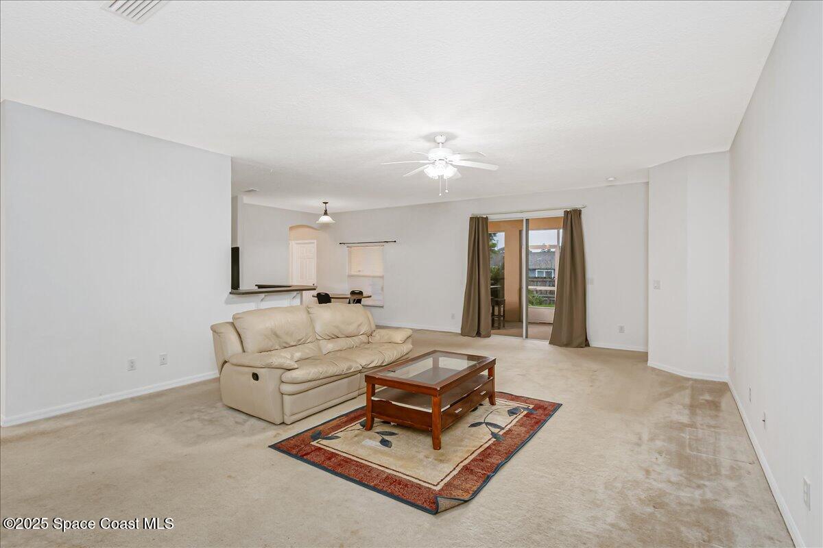 1062 Morgan Circle Northeast Palm Bay, FL 32905 - Photo 15 of 52 a living room with furniture gym equipment and large window