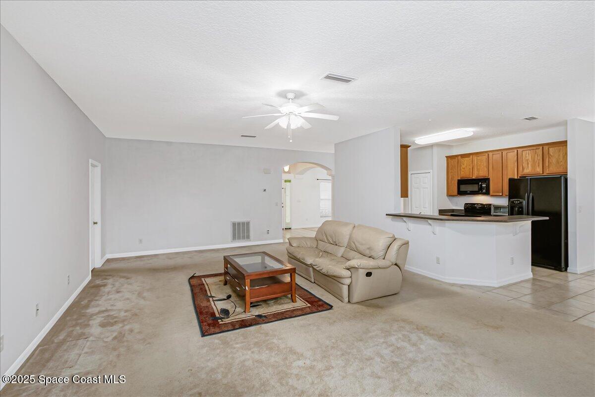 1062 Morgan Circle Northeast Palm Bay, FL 32905 - Photo 17 of 52 a living room with furniture and a chandelier