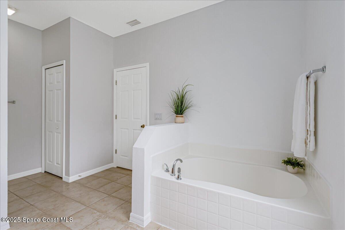 1062 Morgan Circle Northeast Palm Bay, FL 32905 - Photo 22 of 52 a white bath tub sitting next to a shower