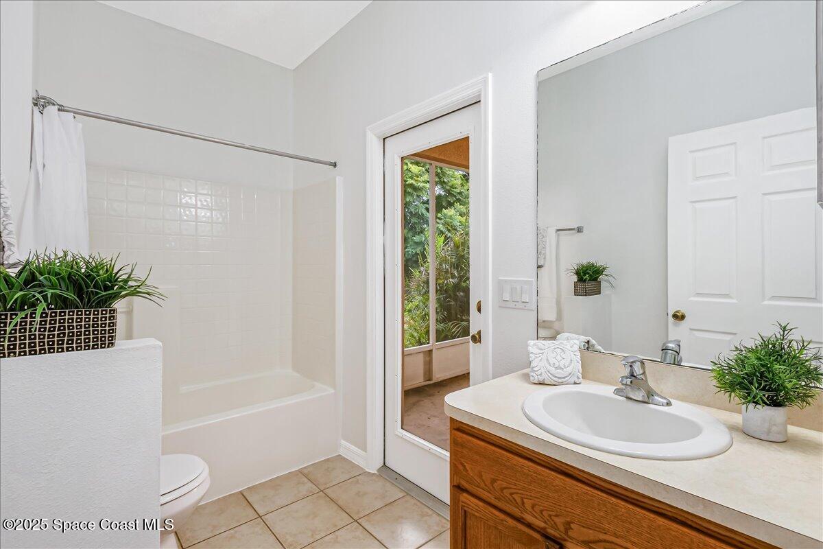1062 Morgan Circle Northeast Palm Bay, FL 32905 - Photo 24 of 52 a bathroom with a sink a bathtub and a mirror