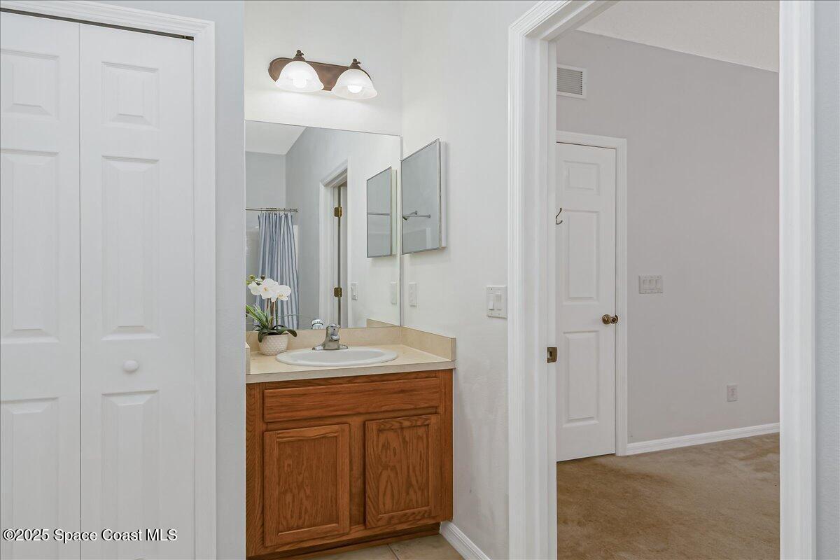 1062 Morgan Circle Northeast Palm Bay, FL 32905 - Photo 27 of 52 a bathroom with a sink and a mirror