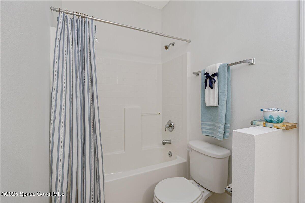1062 Morgan Circle Northeast Palm Bay, FL 32905 - Photo 28 of 52 a bathroom with a granite countertop sink toilet and shower