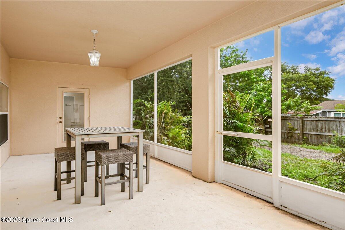 1062 Morgan Circle Northeast Palm Bay, FL 32905 - Photo 30 of 52 a dining room with furniture and a window