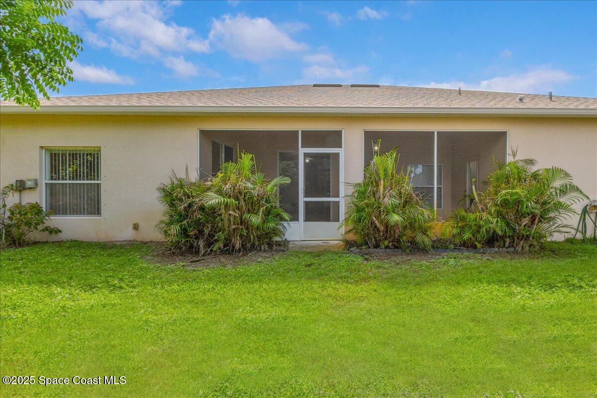 1062 Morgan Circle Northeast Palm Bay, FL 32905 - Photo 31 of 52 a view of a house with a garden