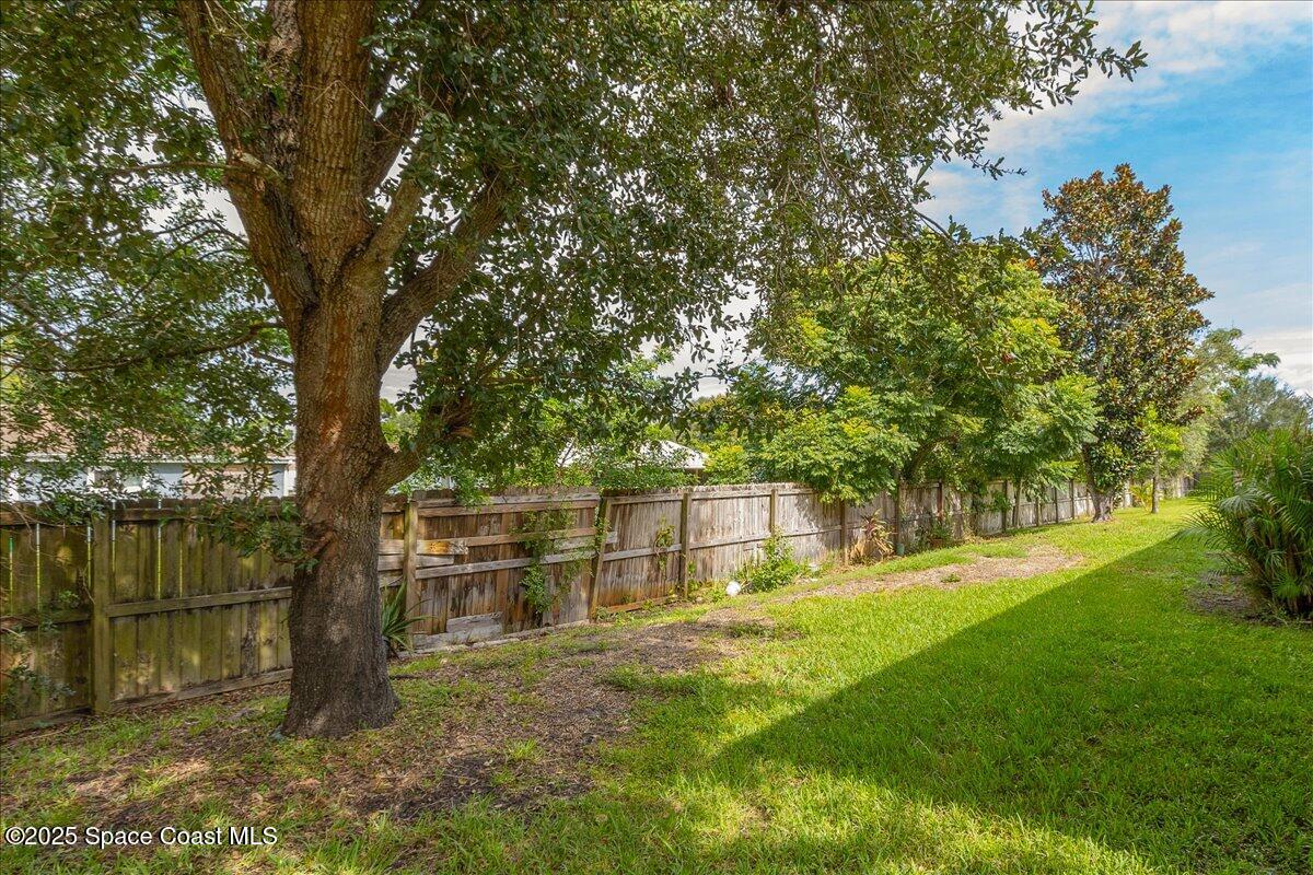 1062 Morgan Circle Northeast Palm Bay, FL 32905 - Photo 33 of 52 a view of outdoor space with deck and trees