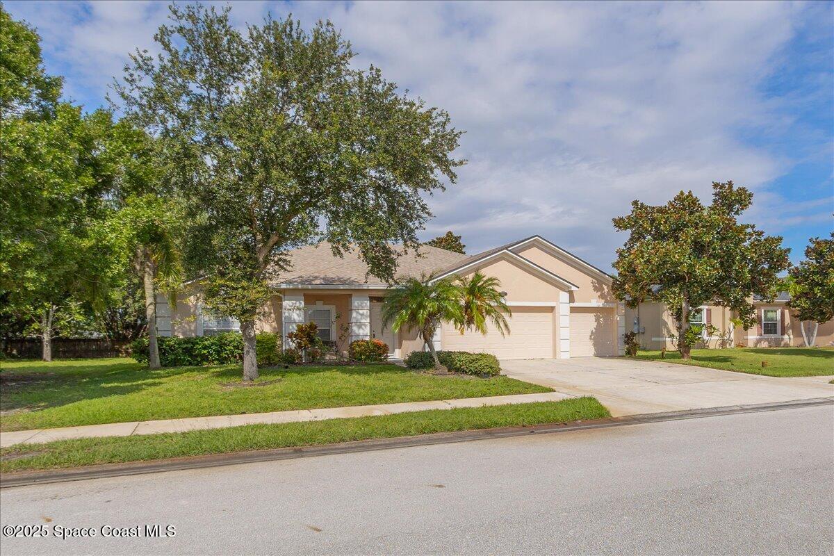 1062 Morgan Circle Northeast Palm Bay, FL 32905 - Photo 36 of 52 a front view of house with yard and green space