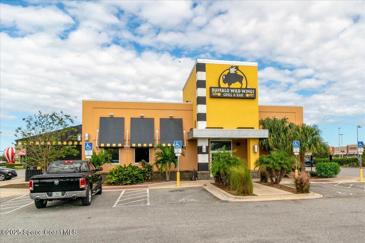 1062 Morgan Circle Northeast Palm Bay, FL 32905 - Photo 40 of 52 a car parked in front of a building