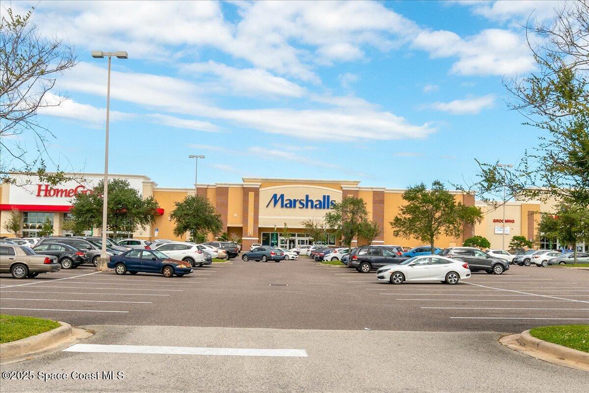 1062 Morgan Circle Northeast Palm Bay, FL 32905 - Photo 43 of 52 a view of road with card parked on side and retail shops