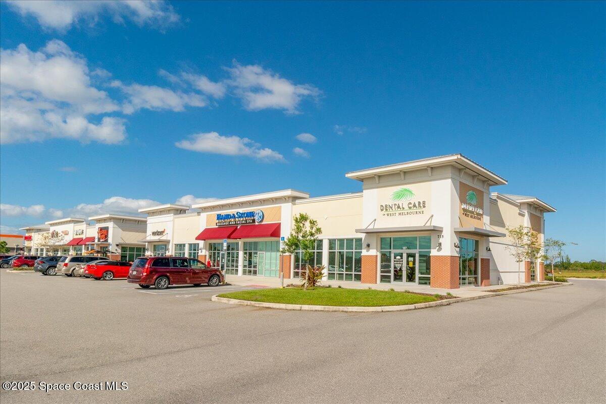 1062 Morgan Circle Northeast Palm Bay, FL 32905 - Photo 49 of 52 a view of a building with car parked