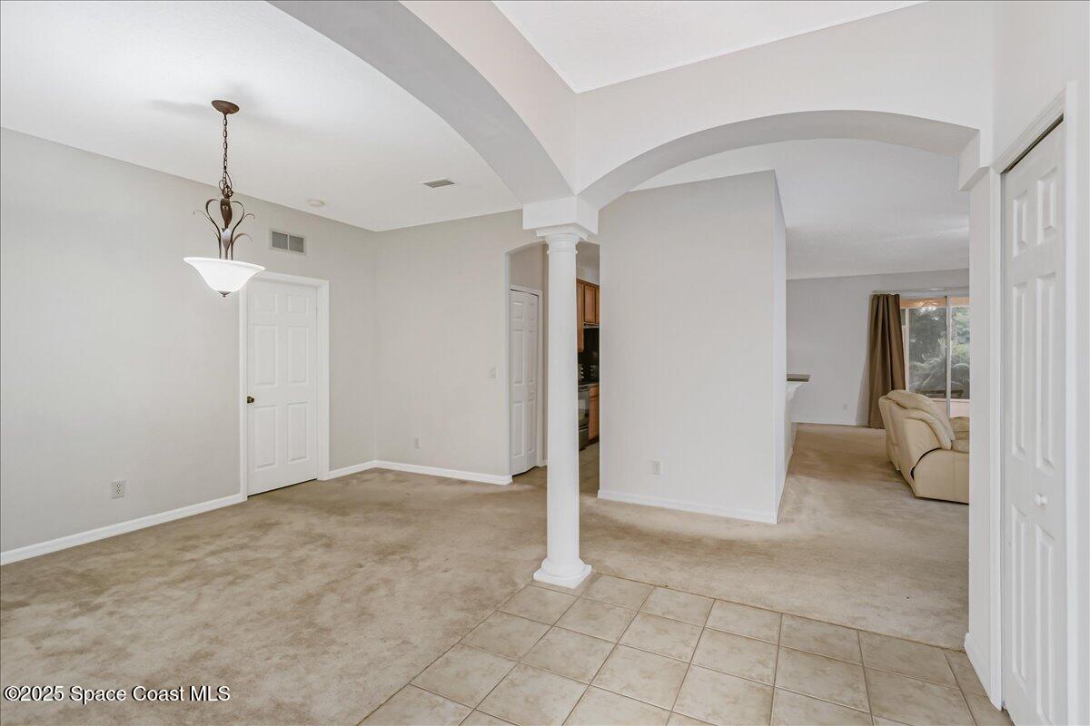 1062 Morgan Circle Northeast Palm Bay, FL 32905 - Photo 5 of 52 a view of a room with a stylish ceiling fan and entryway