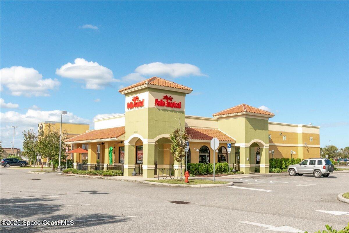 1062 Morgan Circle Northeast Palm Bay, FL 32905 - Photo 52 of 52 a view of a brick building next to a road