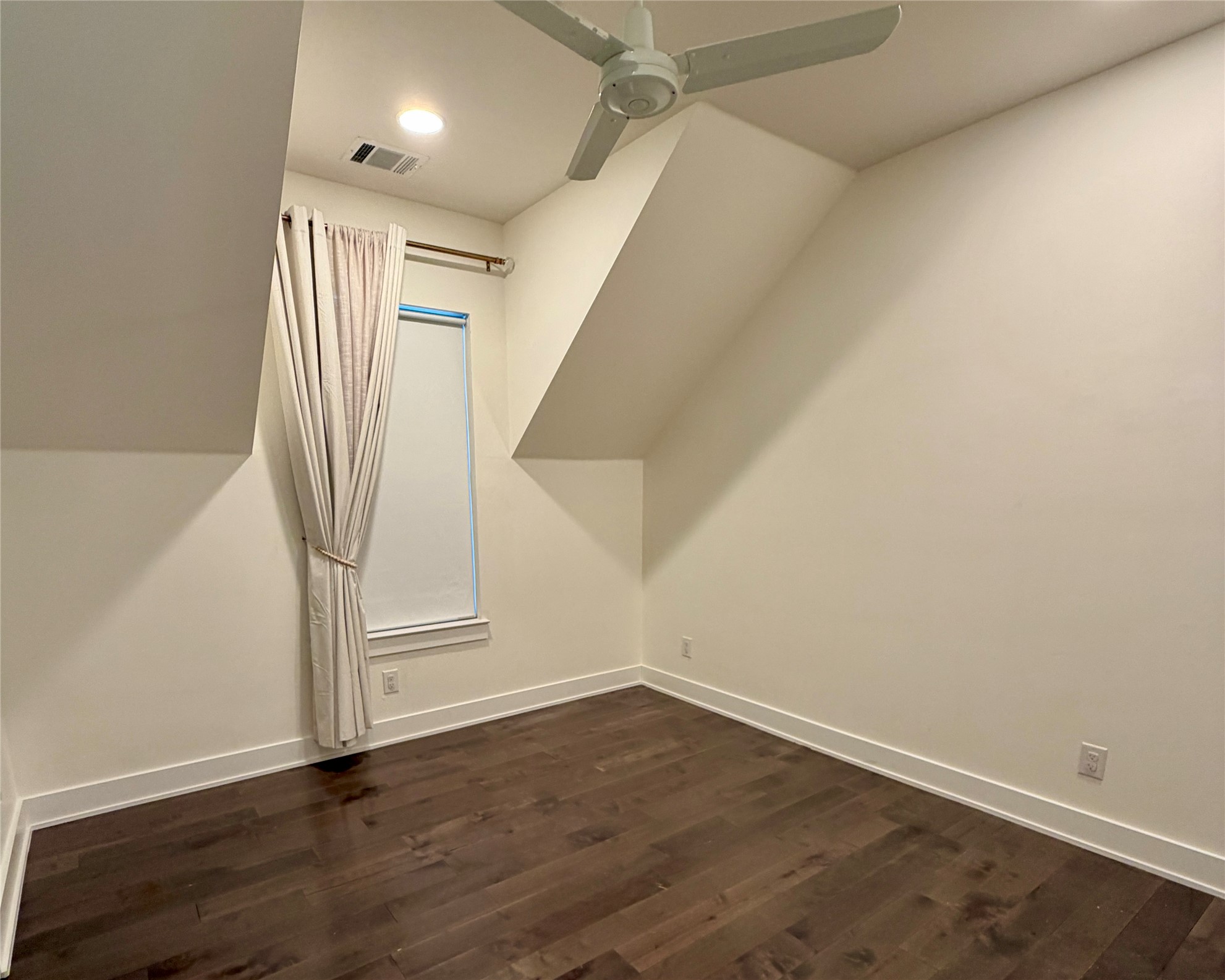1515 Hether Street, Unit B Austin, TX 78704 - Photo 22 of 30 A well-lit bedroom features rich hardwood flooring and a stylish ceiling fan for comfort.