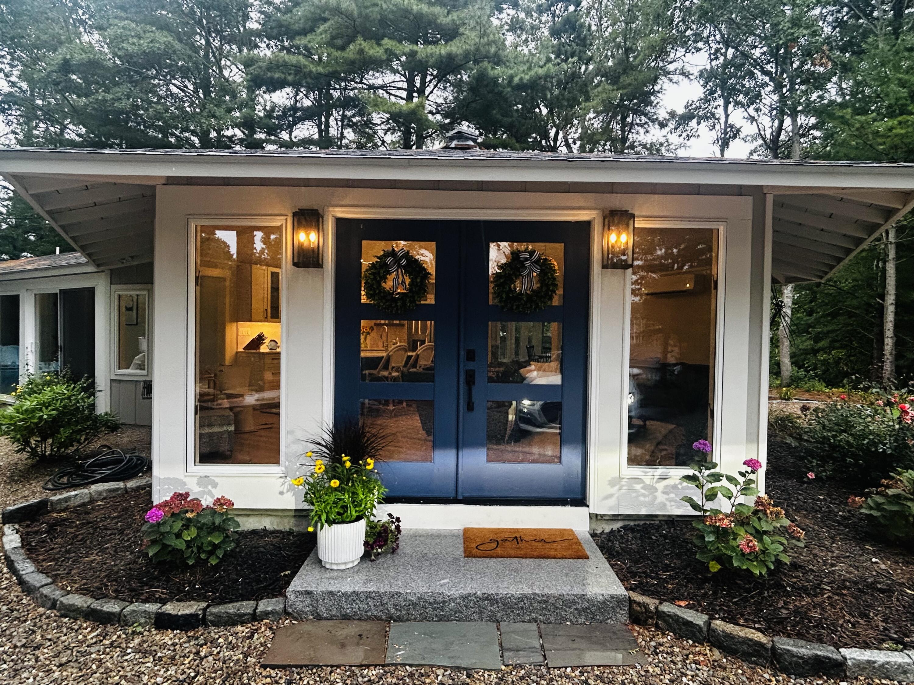 a view of a house with potted plants