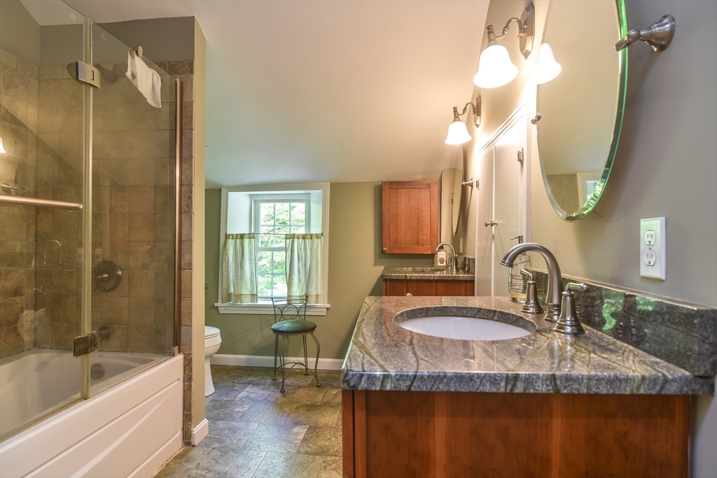 33 Grove Street Framingham, MA 01701 - Photo 18 of 33 a bathroom with a granite countertop sink a toilet and bathtub