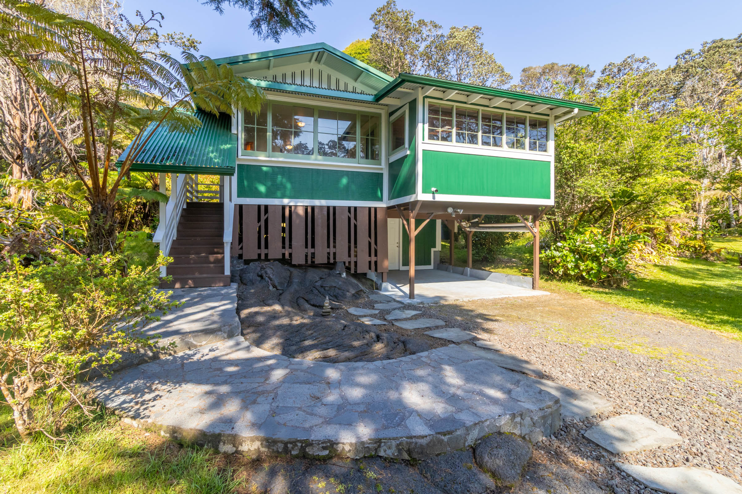 19-4035 Wright Road Volcano, HI 96785 - Photo 1 of 25 a front view of a house with a yard and potted plants