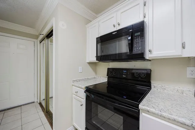 a view of empty room with a fireplace and wooden floor