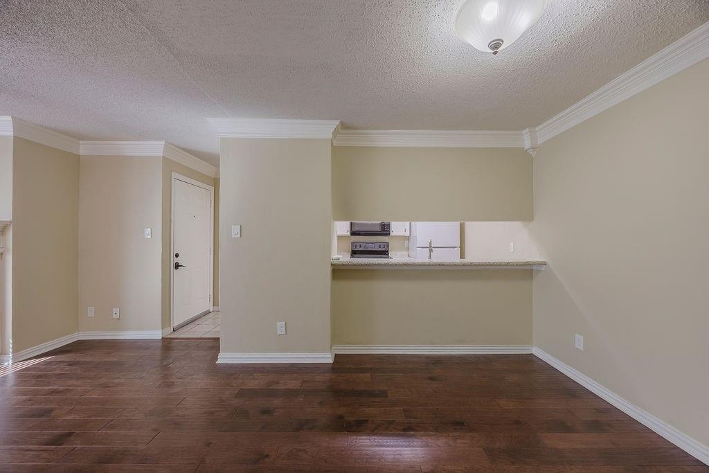 2200 East Trinity Mills Road, Unit 214 Carrollton, TX 75006 - Photo 17 of 25 a view of empty room with wooden floor