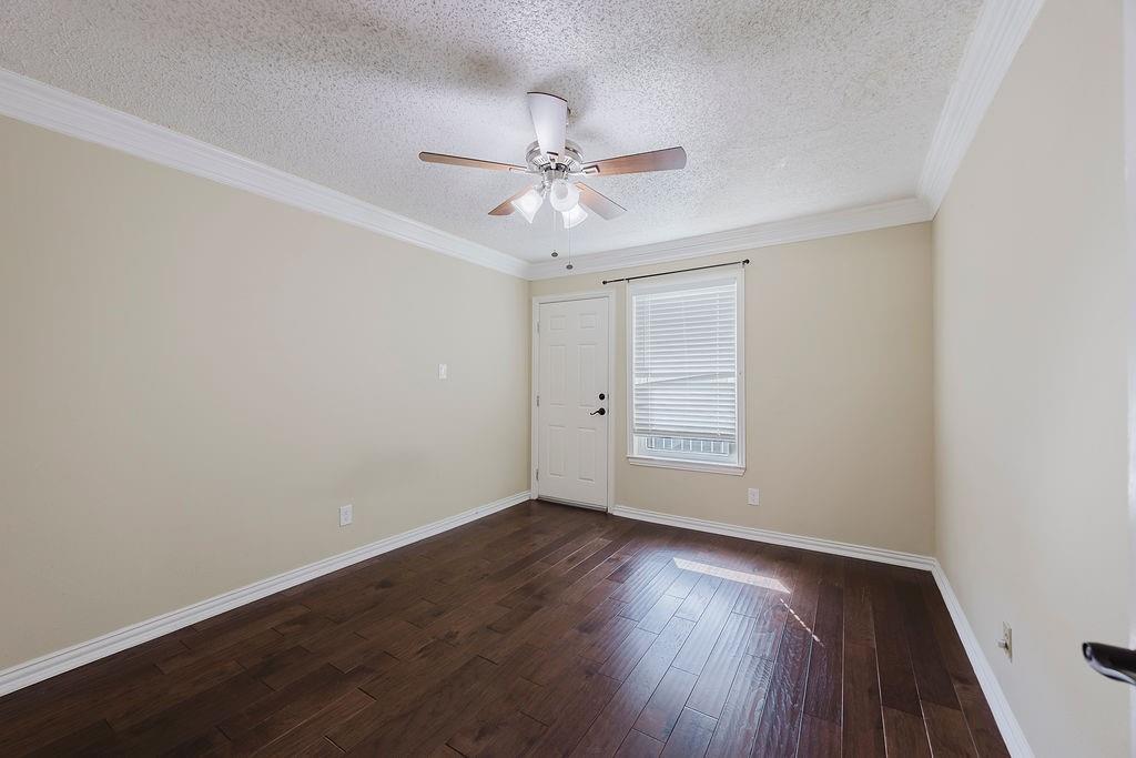 2200 East Trinity Mills Road, Unit 214 Carrollton, TX 75006 - Photo 20 of 25 wooden floor in an empty room with a window
