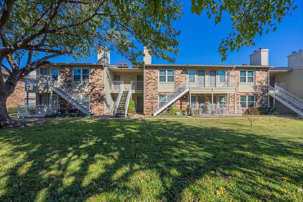 2200 East Trinity Mills Road, Unit 214 Carrollton, TX 75006 - Photo 2 of 25 a view of a house with a yard