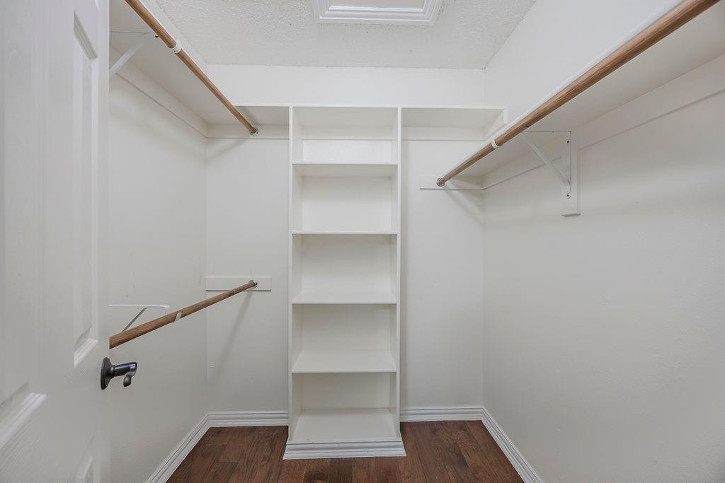 2200 East Trinity Mills Road, Unit 214 Carrollton, TX 75006 - Photo 22 of 25 a view of walk in closet with empty racks