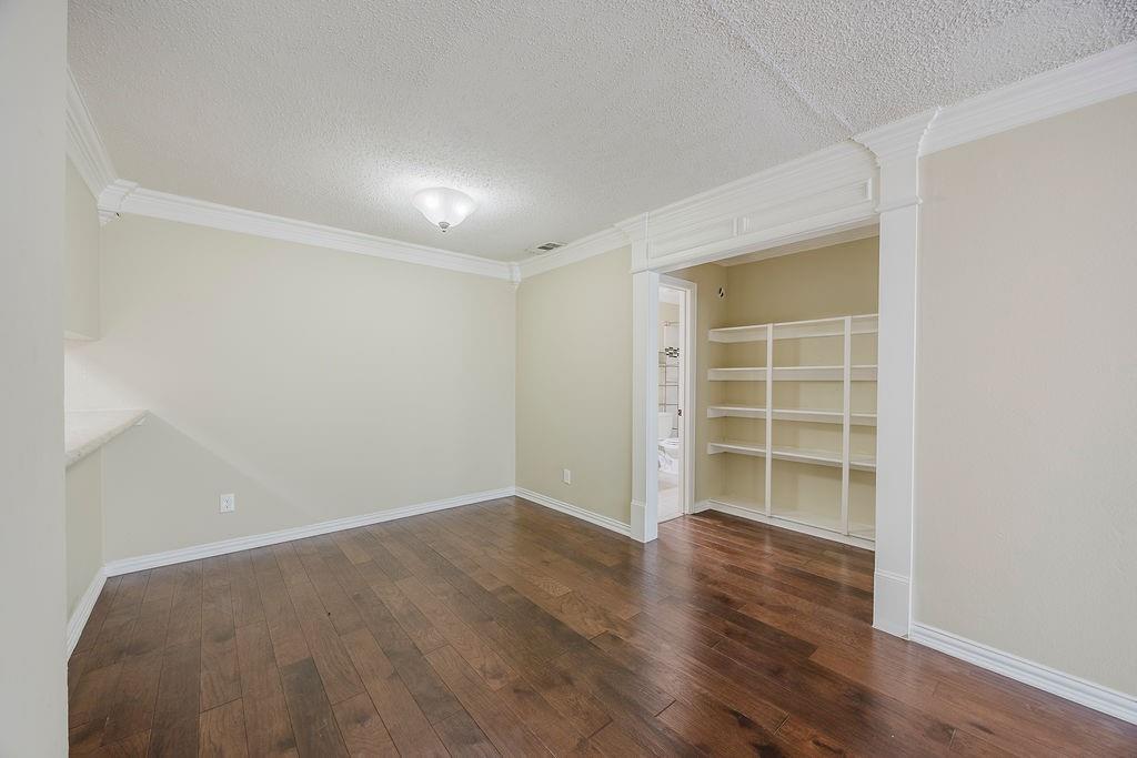 2200 East Trinity Mills Road, Unit 214 Carrollton, TX 75006 - Photo 25 of 25 wooden floor in an empty room with a window