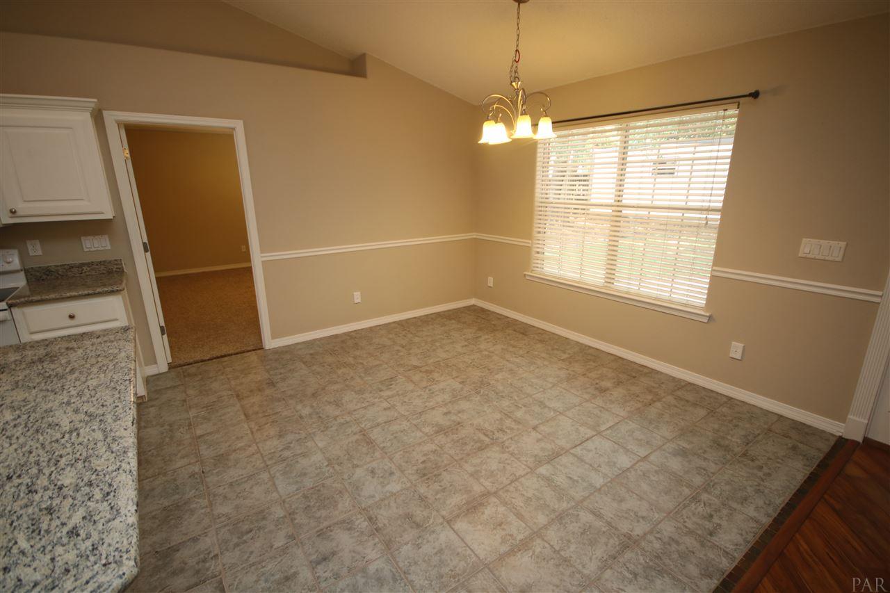 4722 Ridge Pointe Drive Pace, FL 32571 - Photo 12 of 50 chair rail. Master suite through door to the left.