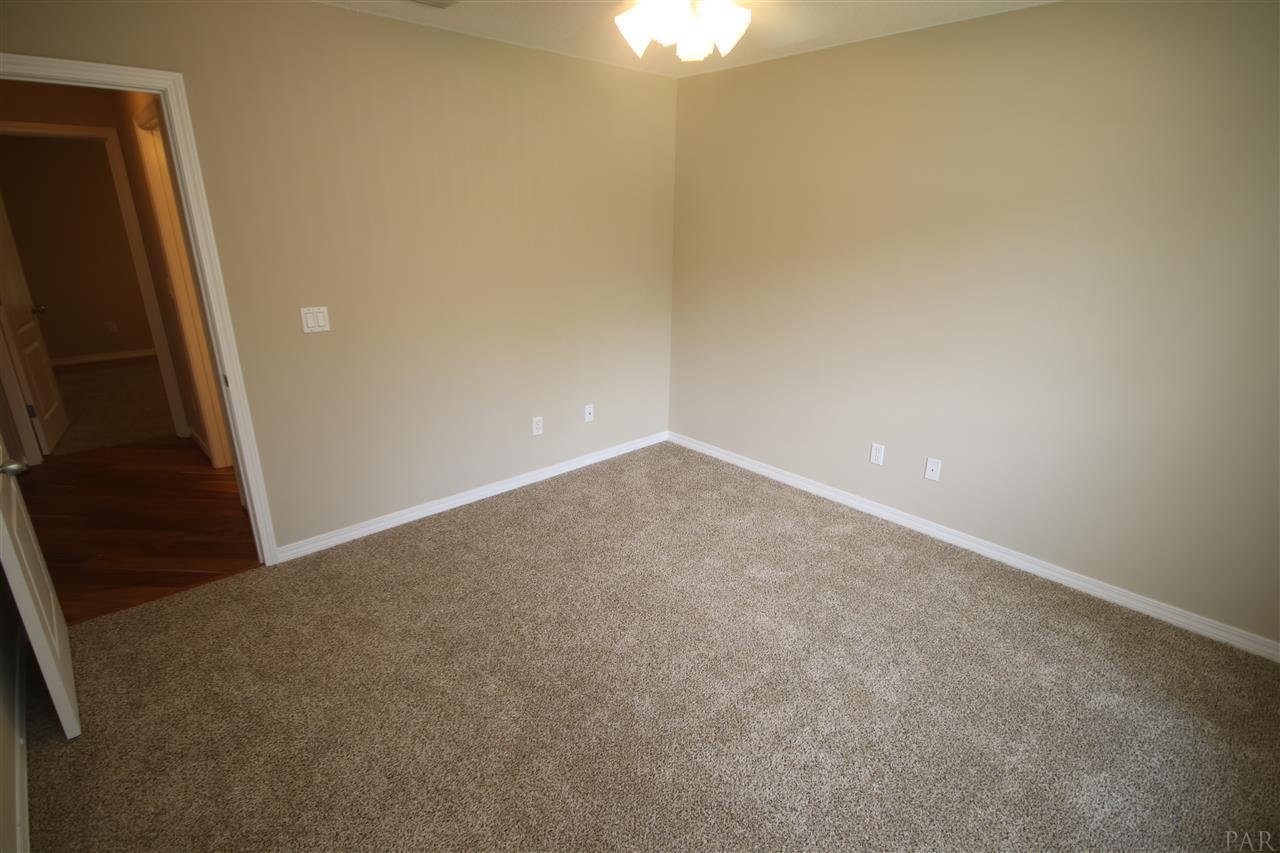 4722 Ridge Pointe Drive Pace, FL 32571 - Photo 36 of 50 at the end of the hallway, full bath to the right.