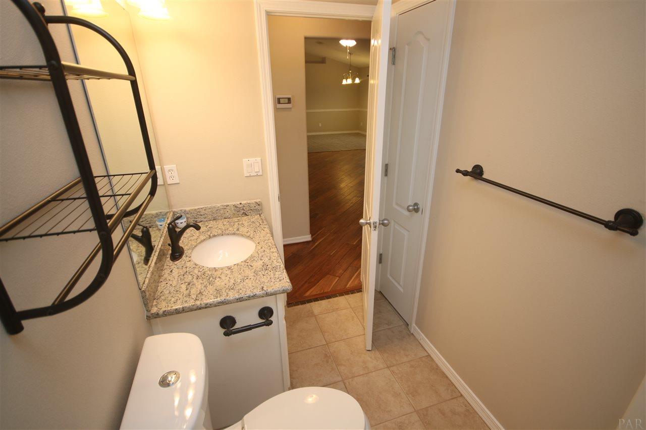 4722 Ridge Pointe Drive Pace, FL 32571 - Photo 39 of 50 Elongated toilet w/ push button flush.