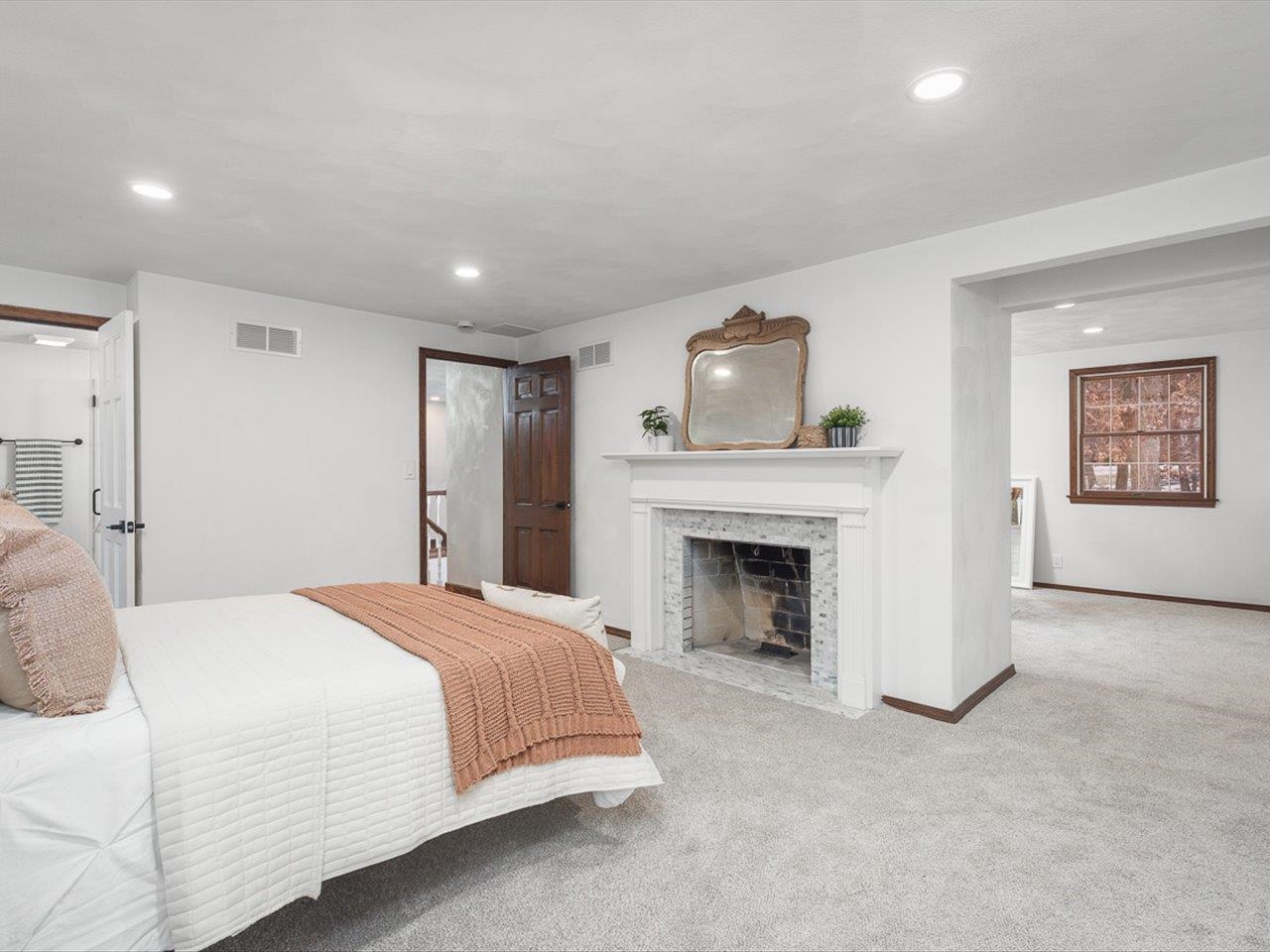 1927 Baintree Road Lake Summerset, IL 61019 - Photo 34 of 71 a spacious bedroom with a bed and a fireplace