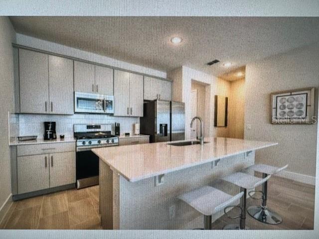 7841 Spectrum Drive Kissimmee, FL 34747 - Photo 1 of 1 a large kitchen with cabinets table and chairs