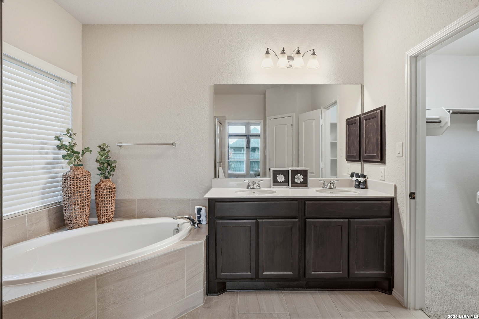 2129 Range Road Seguin, TX 78155 - Photo 24 of 41 a bathroom with a tub sink and mirror