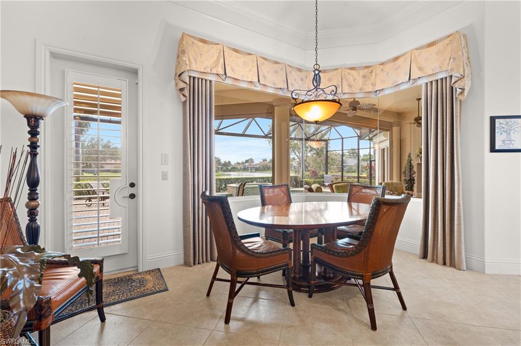 7833 Classics Drive Naples, FL 34113 - Photo 16 of 43 Tiled dining space featuring ornamental molding