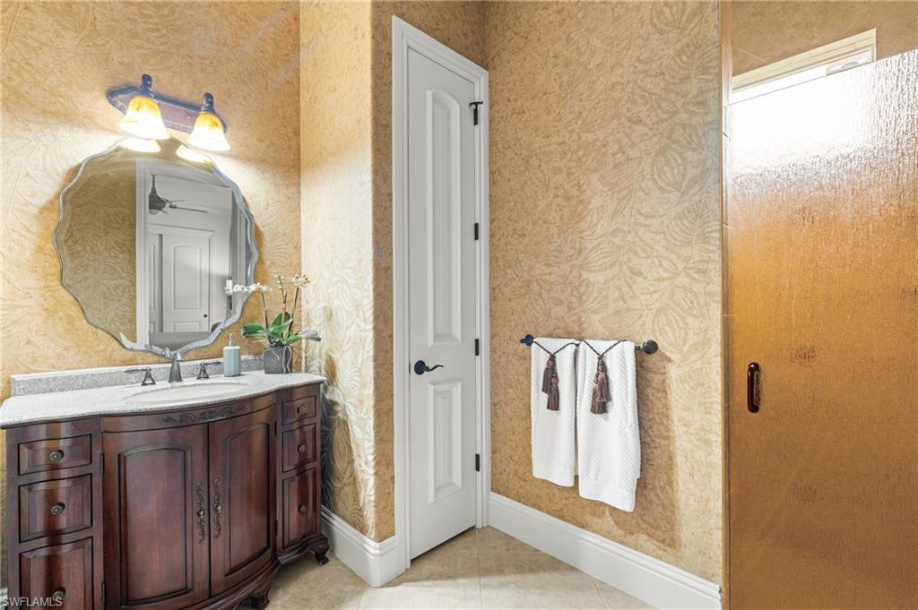 7833 Classics Drive Naples, FL 34113 - Photo 26 of 43 Bathroom with tile patterned floors and vanity