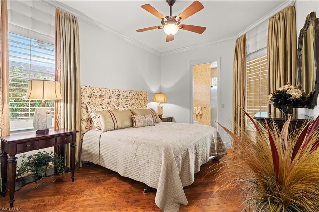 7833 Classics Drive Naples, FL 34113 - Photo 27 of 43 Bedroom with ceiling fan, crown molding, dark hardwood / wood-style floors, and ensuite bath
