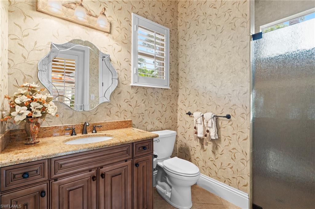 7833 Classics Drive Naples, FL 34113 - Photo 30 of 43 Bathroom featuring toilet, tile patterned flooring, and vanity