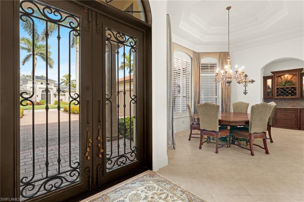 7833 Classics Drive Naples, FL 34113 - Photo 4 of 43 Tiled entrance foyer featuring french doors, ornamental molding, an inviting chandelier, and a tray ceiling