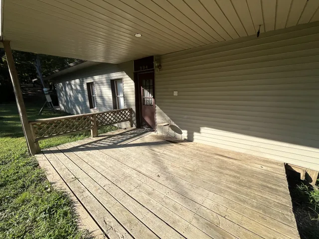 a backyard of a house with barbeque oven table and chairs