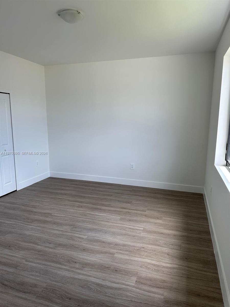 34430 Southwest 190th Avenue Homestead, FL 33034 - Photo 14 of 18 a view of an empty room and wooden floor