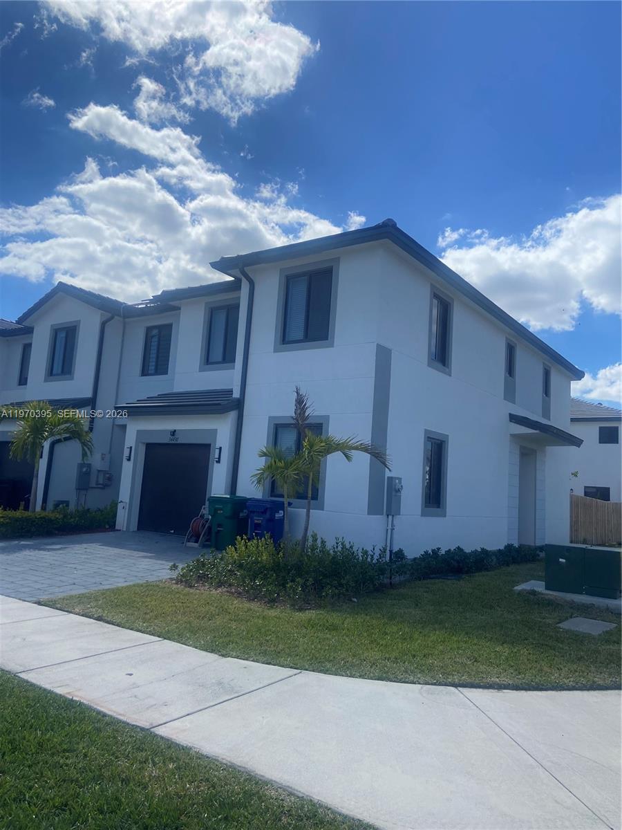 34430 Southwest 190th Avenue Homestead, FL 33034 - Photo 2 of 18 a front view of a house with garden