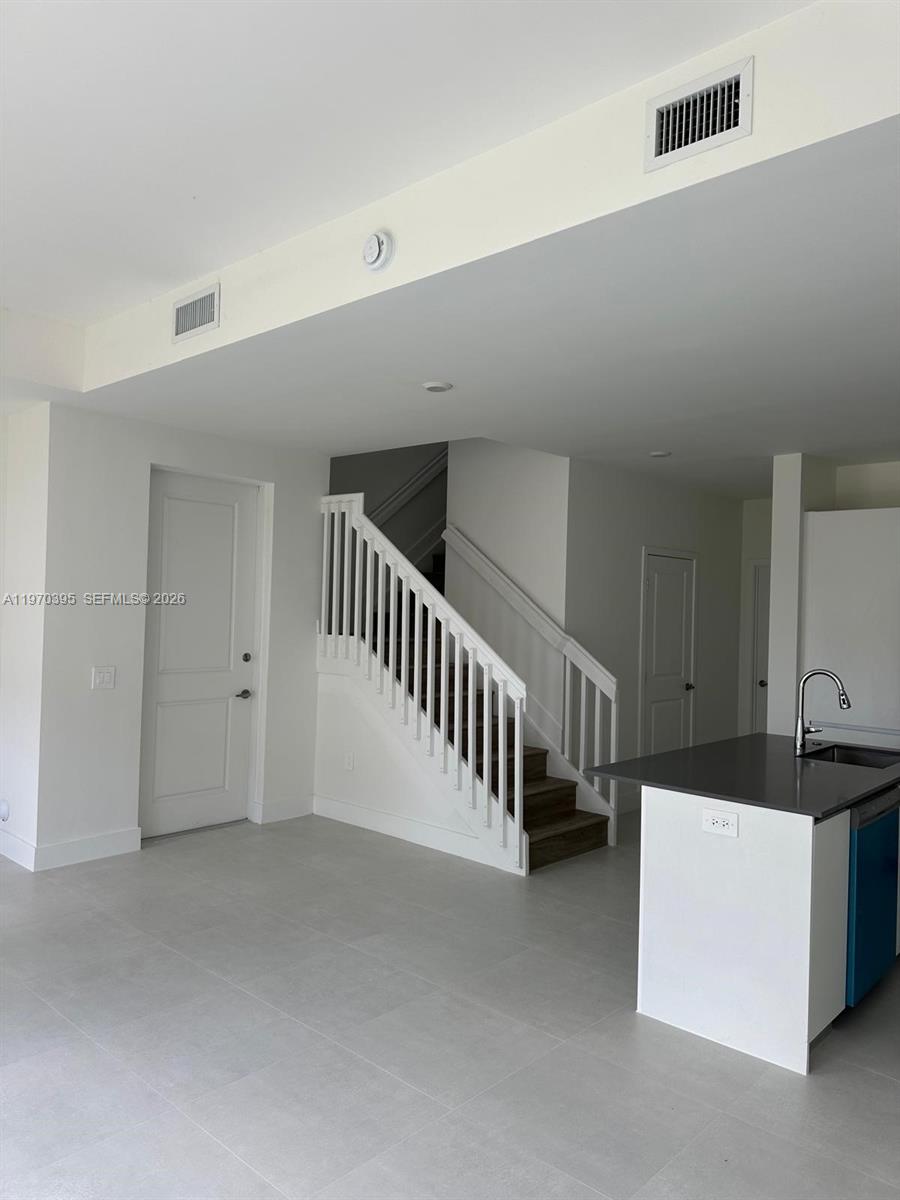 34430 Southwest 190th Avenue Homestead, FL 33034 - Photo 6 of 18 a view of an empty room with stairs