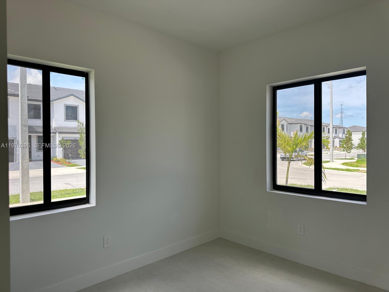 34430 Southwest 190th Avenue Homestead, FL 33034 - Photo 9 of 18 a view of an empty room with a window