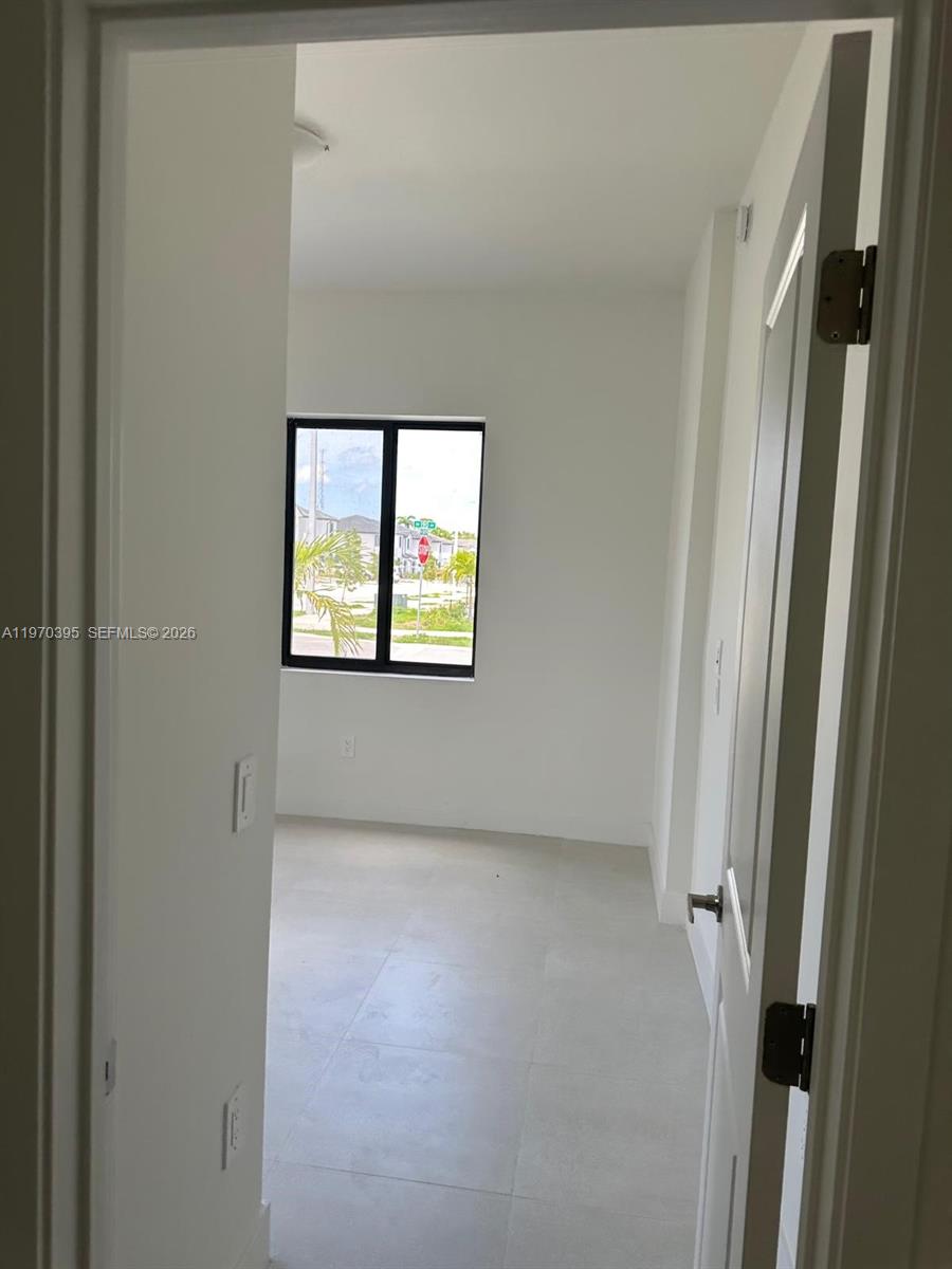 34430 Southwest 190th Avenue Homestead, FL 33034 - Photo 10 of 18 a view of an empty room with a window
